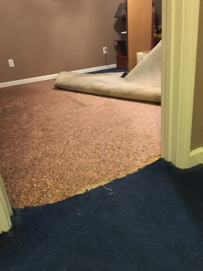 Carpet pad removal revealing water damage during Water Mitigation Services in Cornelius